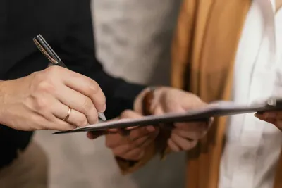 A man signing a document.